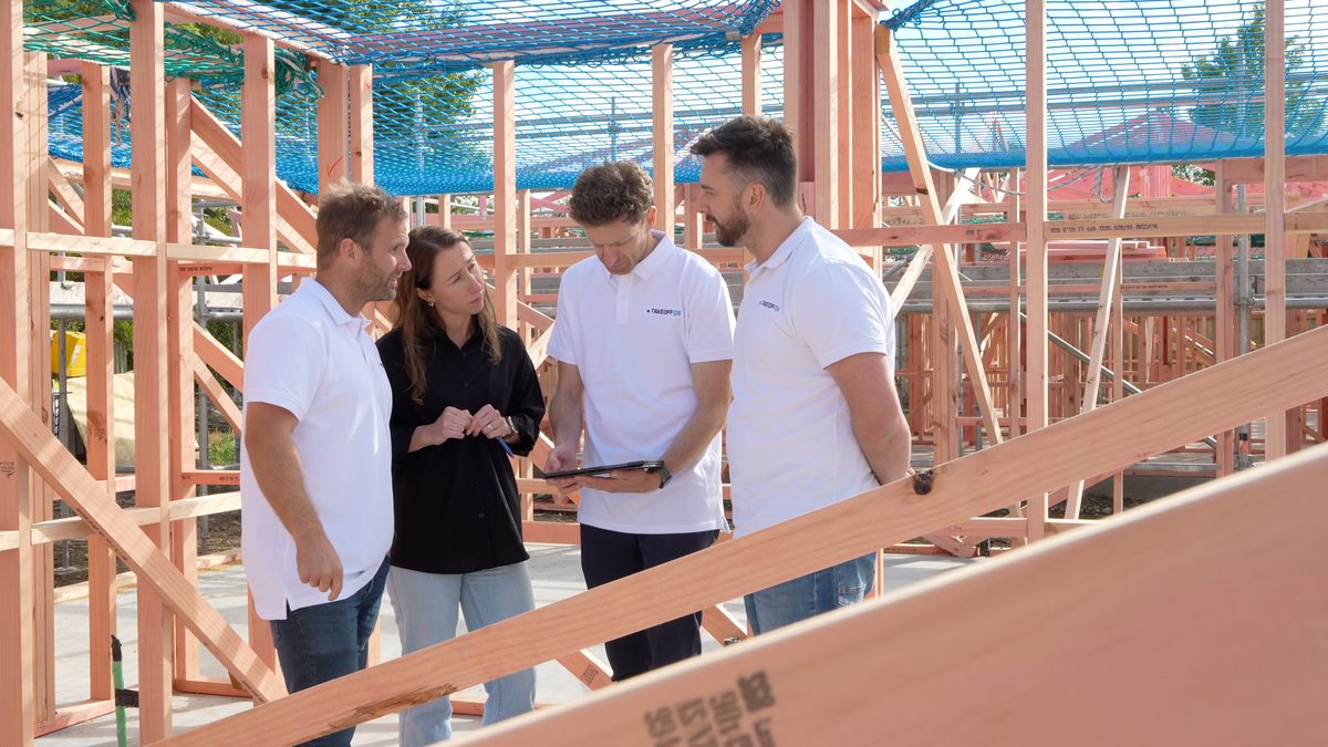 Members of the team reviewing a build on site